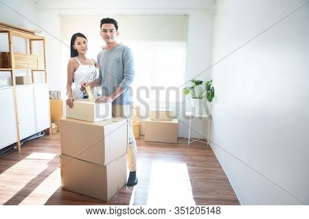 Asian Couple Receive Shipment From Delivery Man, Order Box Shipping From Online Store Website To Del