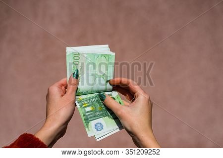 Hand Couting Holding And Showing Euro Money Or Giving Money. World Money Concept, 100 Euro Banknotes