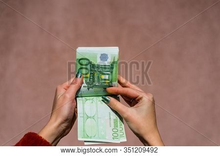 Hand Couting Holding And Showing Euro Money Or Giving Money. World Money Concept, 100 Euro Banknotes