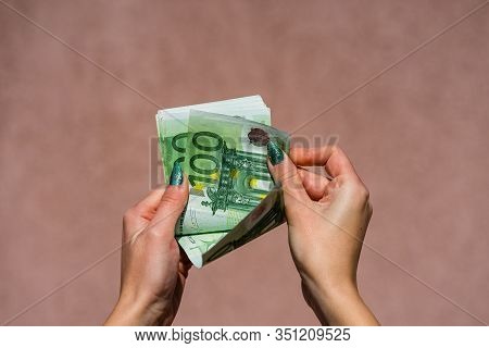 Hand Couting Holding And Showing Euro Money Or Giving Money. World Money Concept, 100 Euro Banknotes