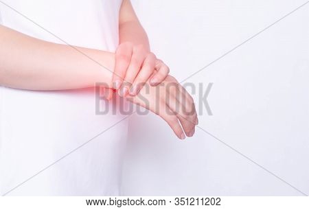 Girl With Pain In The Hand And Wrist On A White Background. The Concept Of Diseases Of The Carpal Ca