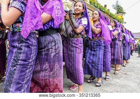 Santiago Atitlan, Guatemala -  April 19, 2019: Maya Women Dressed In Traditional Clothes Carry Good 