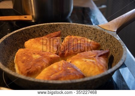 Fry Delicious Homemade Lush Pies With Meat Filling In Hot Vegetable Oil. Pies Are Fried In A Pan. Al