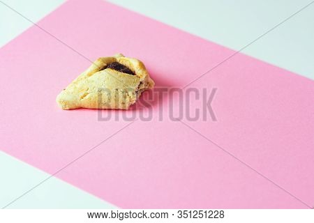 Sweet Cookie With Bite Taken Off. One Hamentashen Purim Cookie Bitten Off.