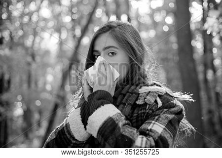 Woman With Napkin Sneezing In The Yellow Park. Sick People Has Runny Nose. Allergy Season. Woman Mak