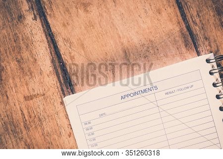 Organizer Or Planner. Vintage Style Appoinments List On A Wooden Table.