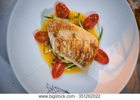 Delicious Fillet Of Grilled And Oven Baked Codfish Or Coalfish Served With Thin Sliced Vegetables An
