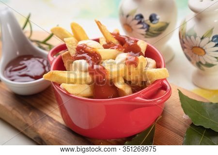 Canadian poutine, fried potato chips with cheese and gravy or sauce
