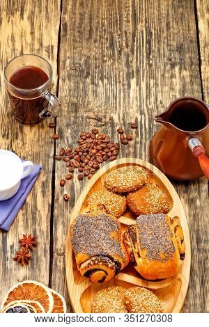 Coffee Beans Are Scattered On An Old Wooden Table And Freshly Brewed Coffee In Transparent Glass Cup