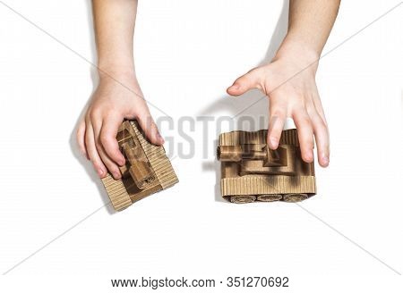 Childrens Hands Play With Tanks. Two Toy Tanks Made By Children From Corrugated Cardboard. Toy Cardb