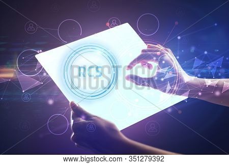 Hand holdig futuristic tablet with RCS inscription, modern technology concept