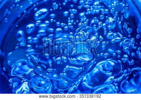 Liquid blue gel bubbles. Polymer gel. Silica gel. Balls of blue hydrogel. Crystal liquid ball with reflection. Texture background. Close up macro. Soapsuds background with air bubbles