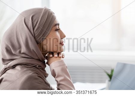 Profile Portrait Of Relaxed Saudi Businesswoman In Hijab Sitting At Wokplace With Thoughtful Face Ex