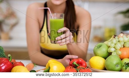 Fit Woman Holding Glass Of Vegetable Detox Smoothie, Standing In Kithcen After Home Training, Panora