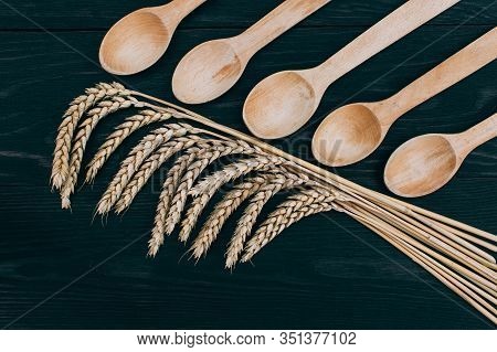 Spikelets Of Ripe Wheat On Wooden Background. Healthy Food