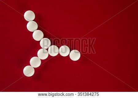 Bacterial Cell Made Of White Tablets With Copy Space For Text On A Red Background, Top View.