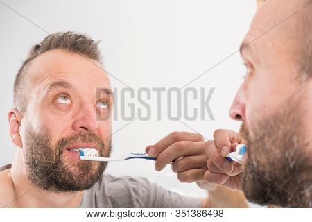 Funnny Guy Taking Care Of His Oral Hygiene, Brushing Teeth During Morning Bathroom Routine.