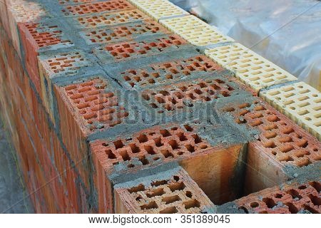An Exhaust Shaft In A Wall Of Red Brick Filled With Cement. Facing With Yellow And Brown Bricks. Sel