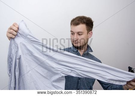 A Man Of About 30 Years Irons His Clothes With An Iron, Leads A Bachelor Lifestyle, Is Going To Visi