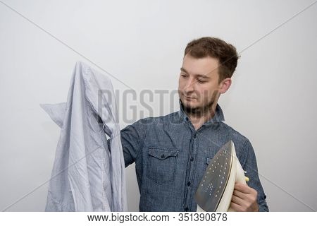 A Man Of About 30 Years Irons His Clothes With An Iron, Leads A Bachelor Lifestyle, Is Going To Visi