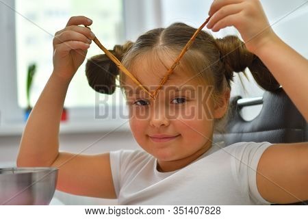 Cinnamon Concept. Girl Grimacing With Cinnamon Sticks. Girl Holding And Smelling Cinnamon Stic. Port