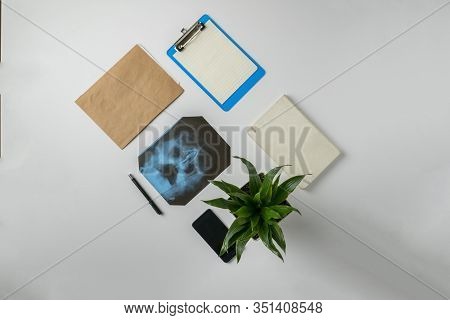 A Flat Lay Medican X-ray Scan Of Bones, Search For Diagnos On The Nurses Table