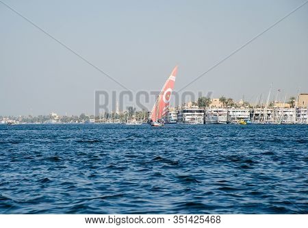 Luxor, Egypt - January 16, 2020 : Nile River Near Luxor, Egypt. A Felucca Is A Traditional Wooden Sa
