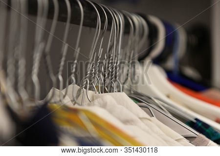 Clothes Hanger Closeup Of Fashion Shop. Aluminium Hanger With Clothes. Clothes In A Cloakroom. Cloth