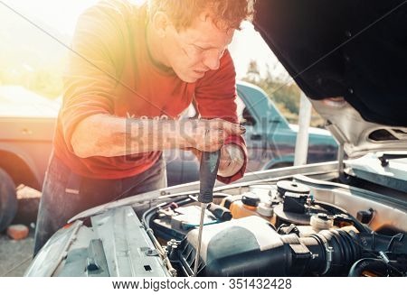 The Concept Of Disability Of People And Their Adaptation To Life. A Blond Disabled Man Repairs A Car