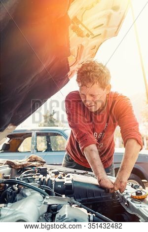 The Concept Of Disability Of People And Their Adaptation To Life. Blond Disabled Man Repairs The Eng