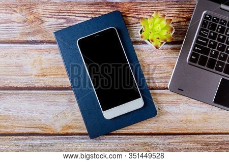 Top View Wooden Office Desk With Smartphone Notepad Laptop Computer Keyboard Office Quipment Supplie