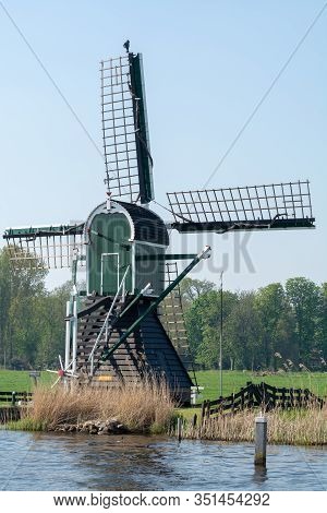 Waterways Of North Holland And View On Traditional Dutch Wind Mill, Dutch Lifestyle Landscape