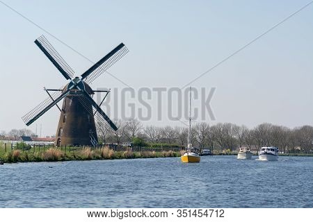 Waterways Of North Holland With Boats And View On Traditional Dutch Mill, Spring Landscape