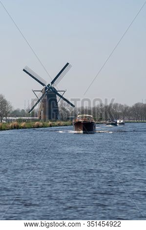 Waterways Of North Holland With Boats And View On Traditional Dutch Mill, Spring Landscape