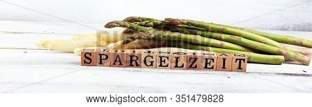 White And Green Asparagus On Background With Spargelzeit Wooden Letter.