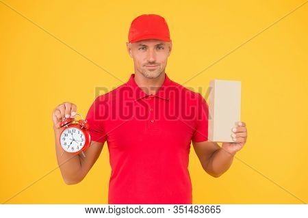 Take Your Shopping Time. Delivery Man Hold Clock And Box Yellow Background. Online Shopping. Cyber M