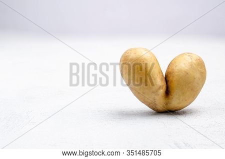 Potatoes In The Shape Of A Heart On A Gray Background, Copy Space Place. Funny, Unusual Concept Of V