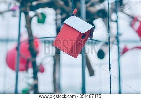 Red Wooden Birdhouse Decoration Hanging On The Thread. Spring Concept