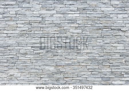 A Limestone Wall In Small Rectangular Blocks For Background