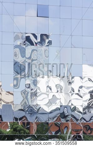 Detail Of Reflective Glazed Building In Which The Surrounding Constructions Are Reflected, Deformed.