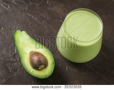 Avocado And A Glass Of Spinach And Avocado Smoothies On A Stone Background. Fitness Product. Dietary