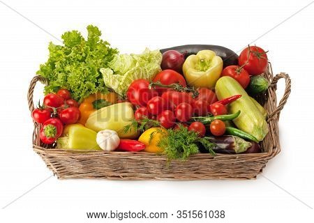 Fresh And Ripe Vegetables Arranged In A Basket Isolated On White. Healthy Organic Food.