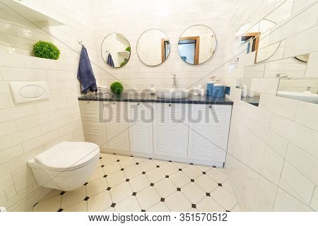 Bathroom In A Residential Building. Dressing Table With Mirrors. Sink With Candles And Soap. The Toi