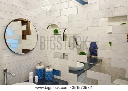 Bathroom In A Residential Building. Dressing Table With Mirrors. Sink With Candles And Soap. A Towel