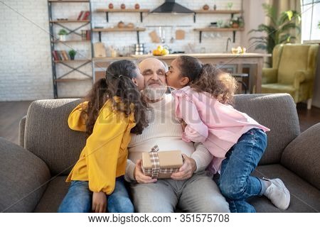 Two Dark-skinned Sisters Kissing Their Grandad And Giving Hime Bday Gift