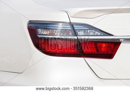 Closeup Of Car Tail Light On A White Car. Generic Brandless Sports Car Taillights Detail.