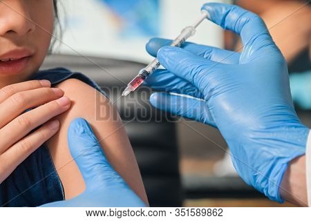 Little Child Having Injection, Close-up Doctor Injecting Vaccination To Arm Of Asian Little Girl Vac
