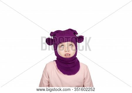 Funny Little Girl In Purple Wool Winter Balaclava Or Knitted Cap Making Funny Faces. Gigl In Winter 