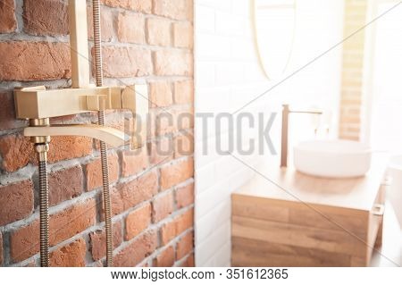 Modern Shower System Copper Color For Bathroom In Loft Style, Brick Wall. Sunlight Window