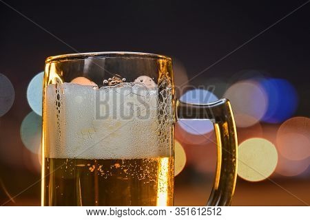 Cold Beer In A Colorful Summer Night Party , Close Up Beer Mug On Night Light Bokeh Background